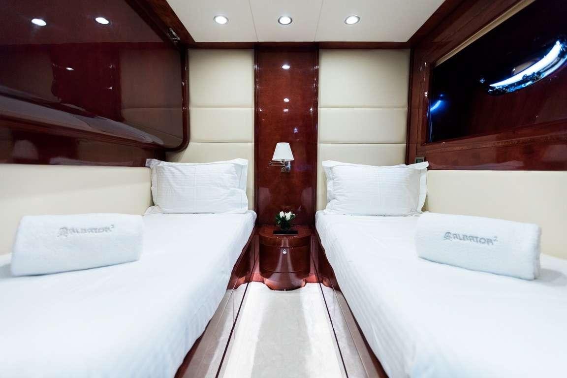 a room with beds and a table aboard ALBATOR 2 Yacht for Charter