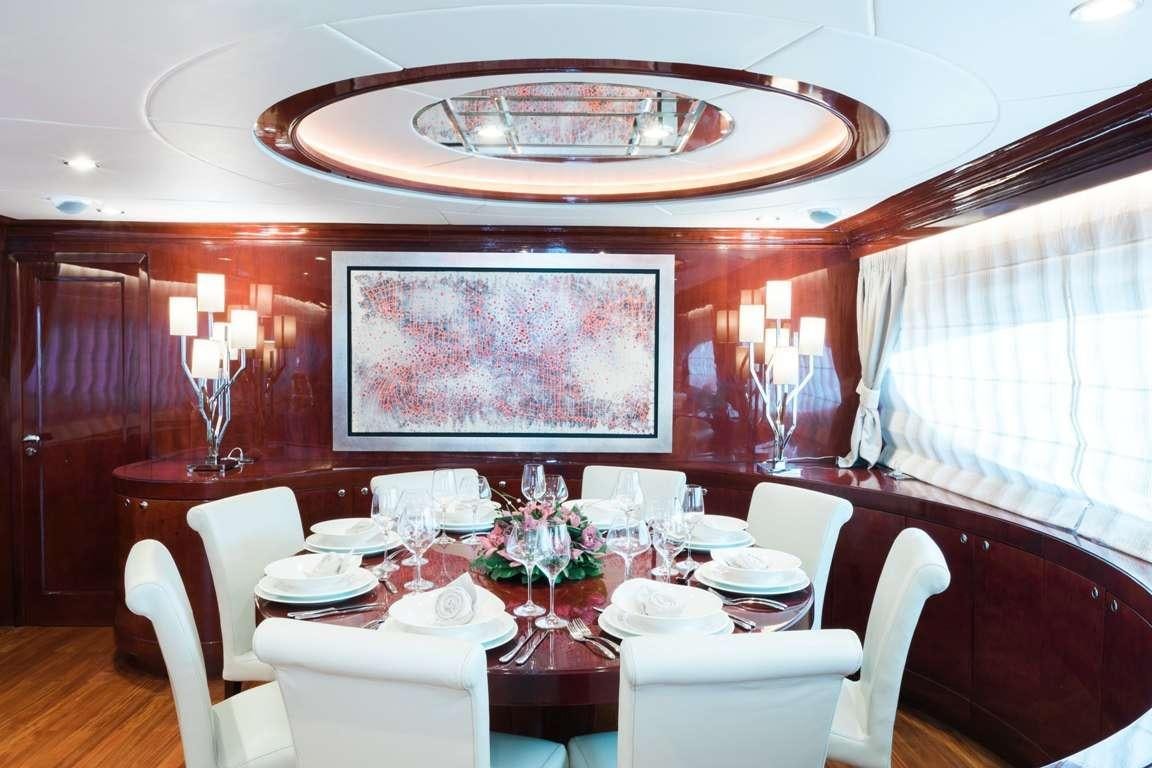a dining room with a table set for a formal dinner aboard ALBATOR 2 Yacht for Charter