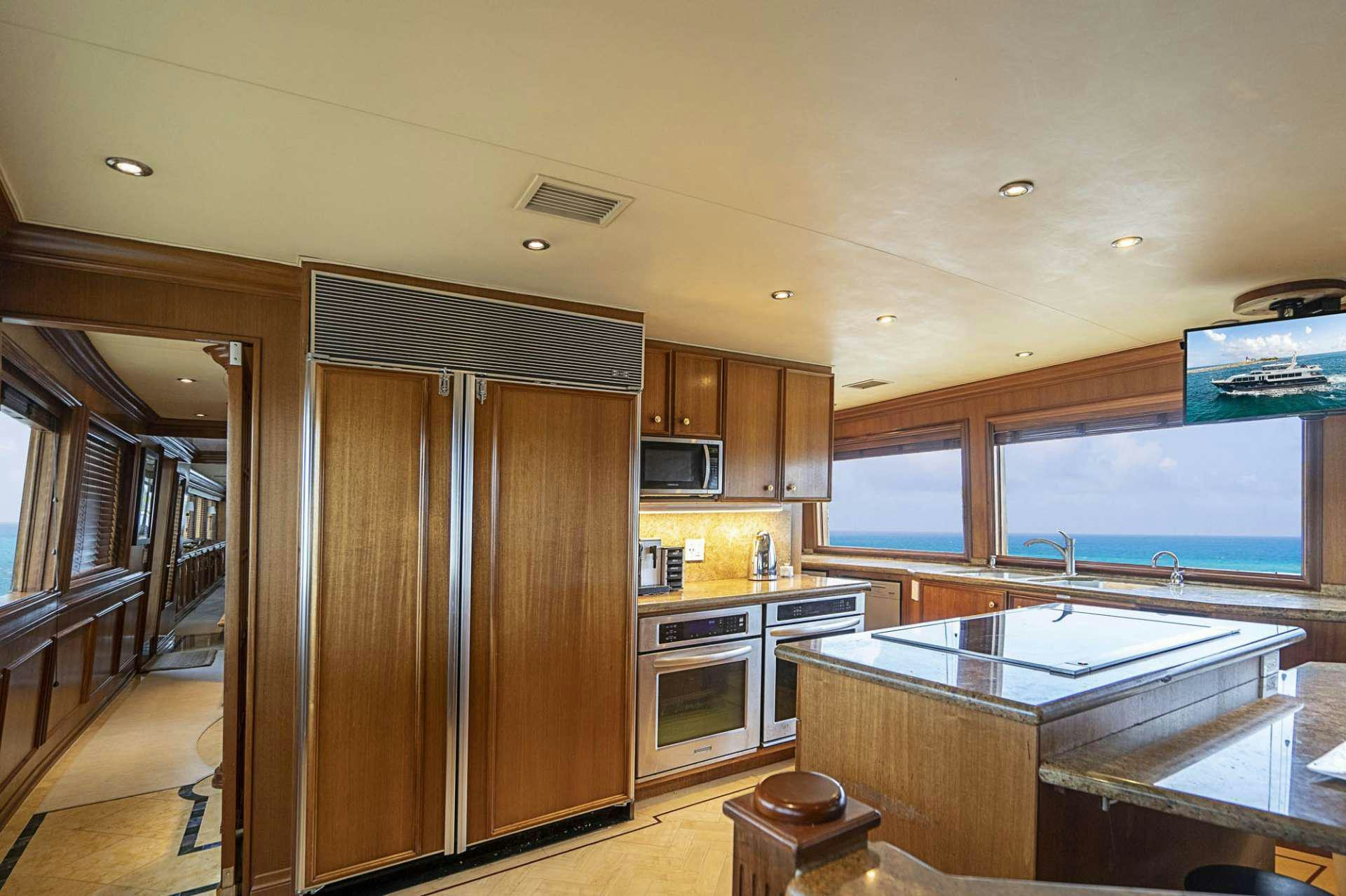 a kitchen with wooden cabinets aboard TRUE NORTH Yacht for Charter