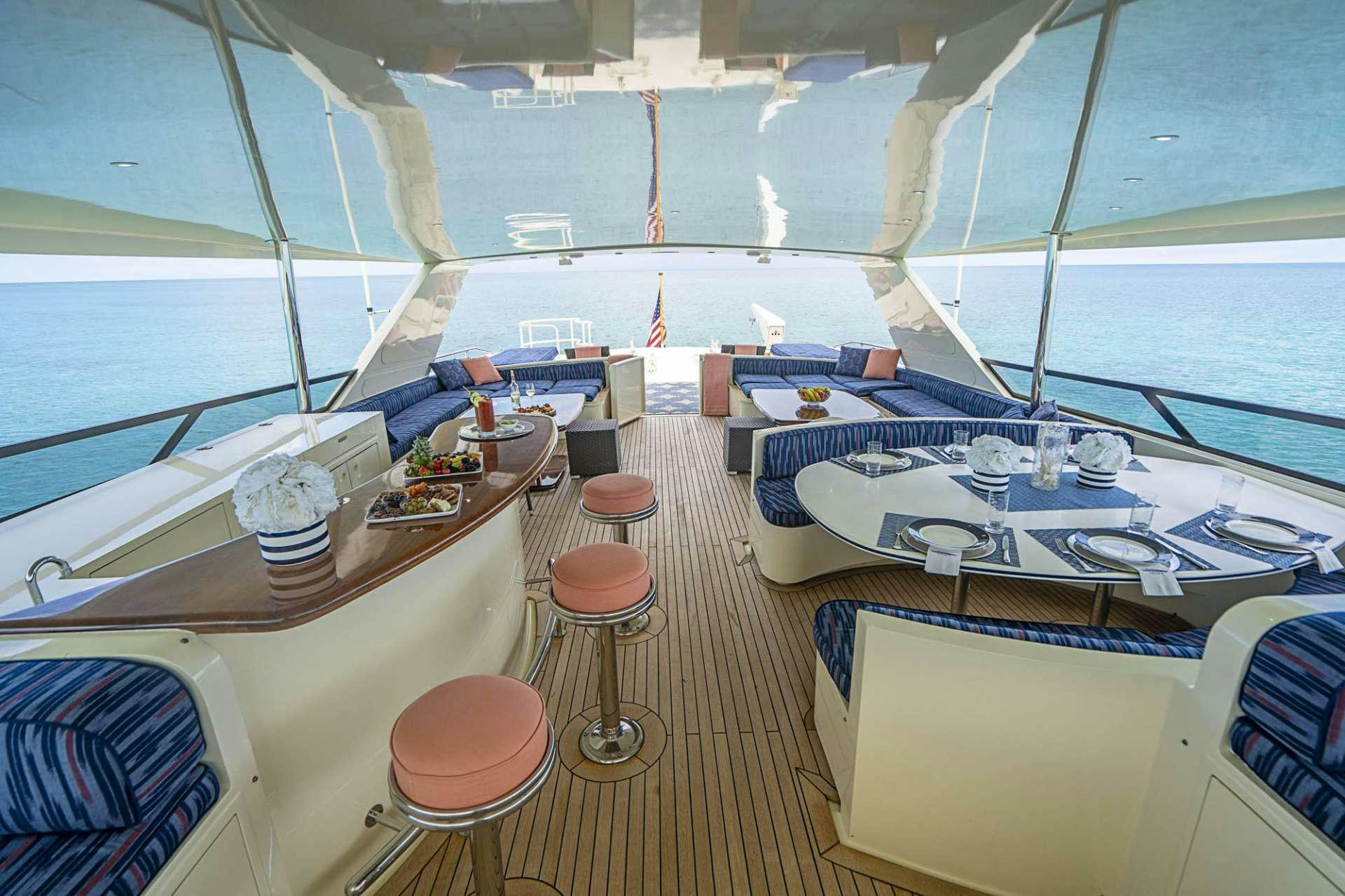 a boat with a table and chairs aboard TRUE NORTH Yacht for Charter