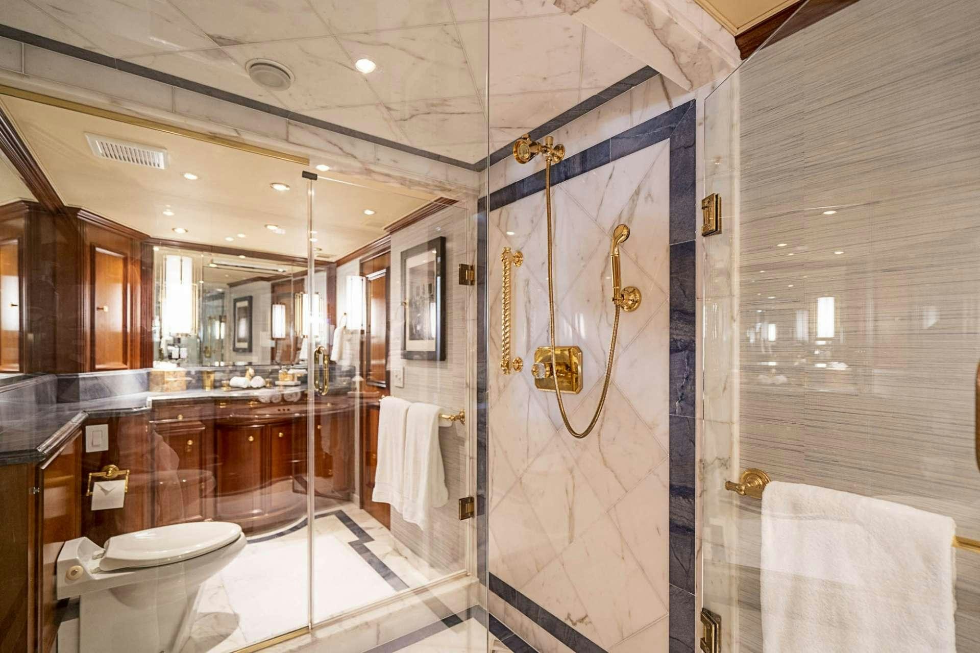 a bathroom with a shower curtain and sink aboard TRUE NORTH Yacht for Charter