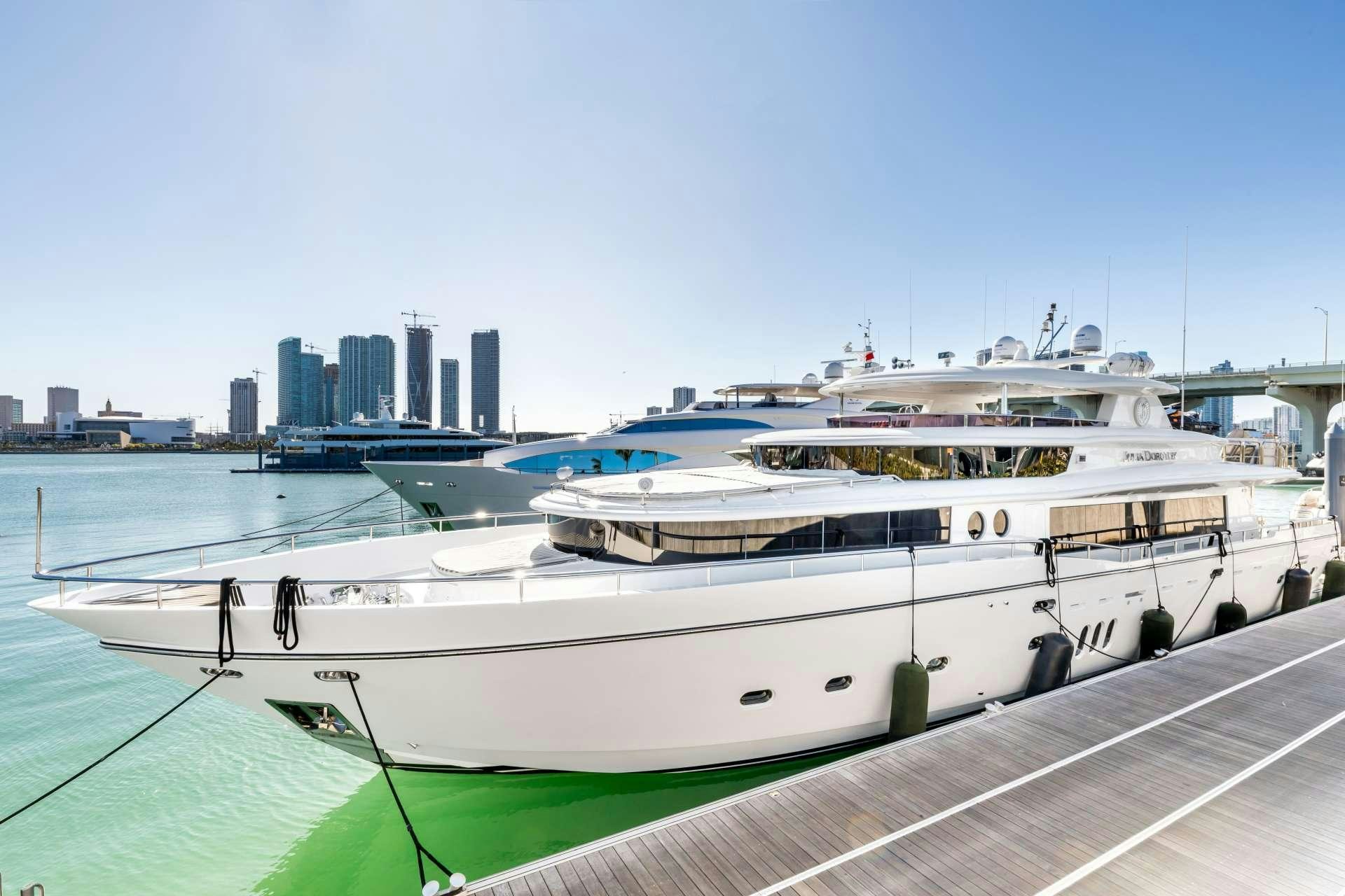 a large white boat in a harbor aboard JULIA DOROTHY Yacht for Charter