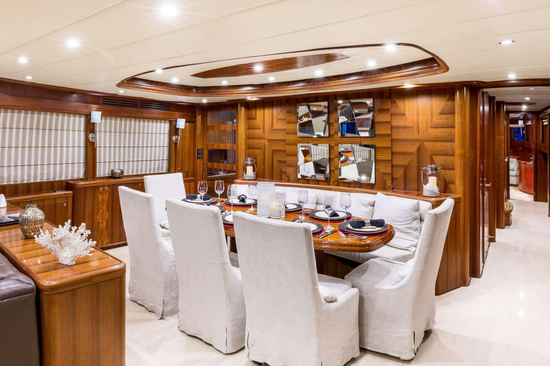 a large room with a table and chairs aboard JULIA DOROTHY Yacht for Charter