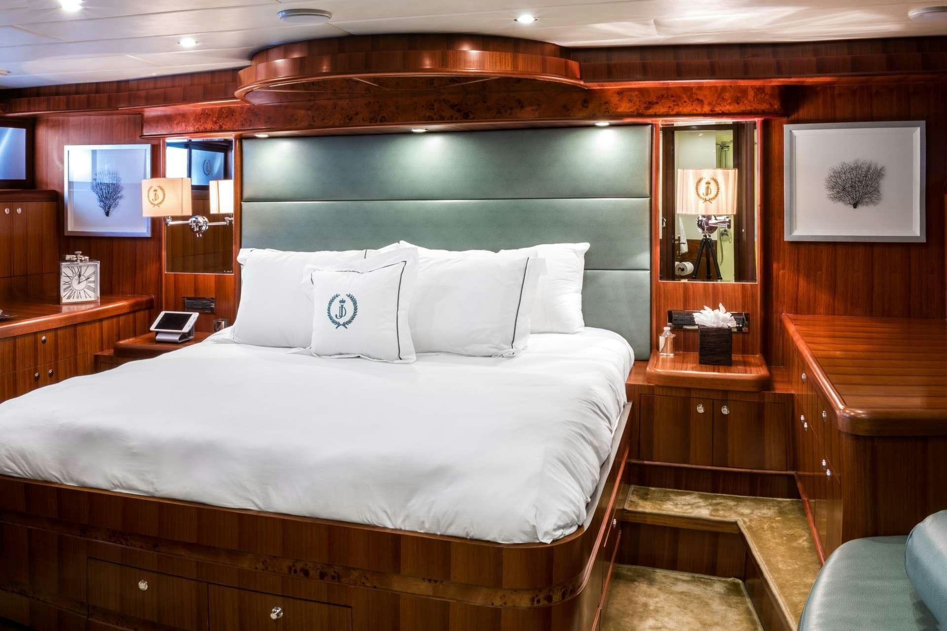 a bed with white sheets aboard JULIA DOROTHY Yacht for Charter