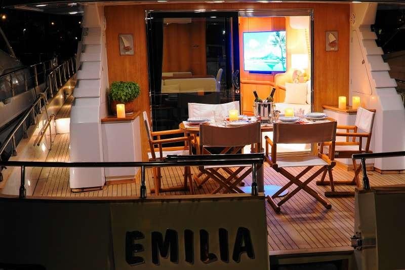 a room with tables and chairs aboard EMILIA Yacht for Charter