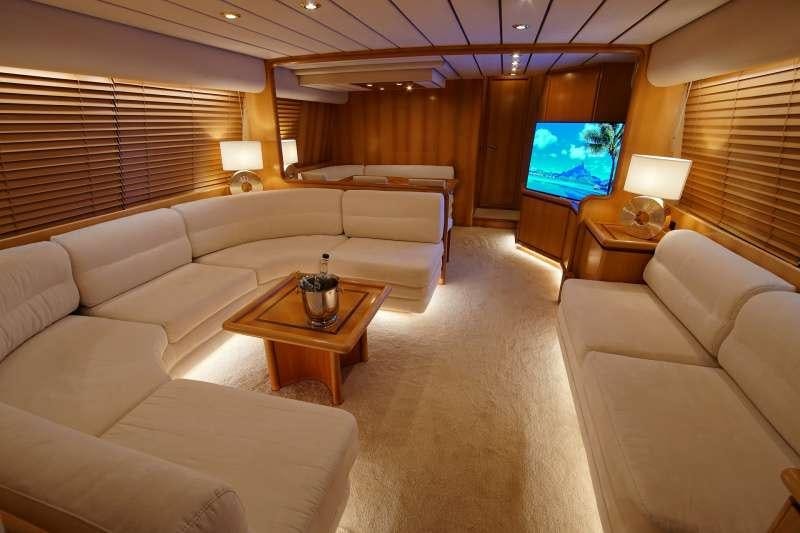 a living room with a large screen aboard EMILIA Yacht for Charter