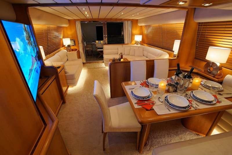 a hotel room with a table and chairs aboard EMILIA Yacht for Charter