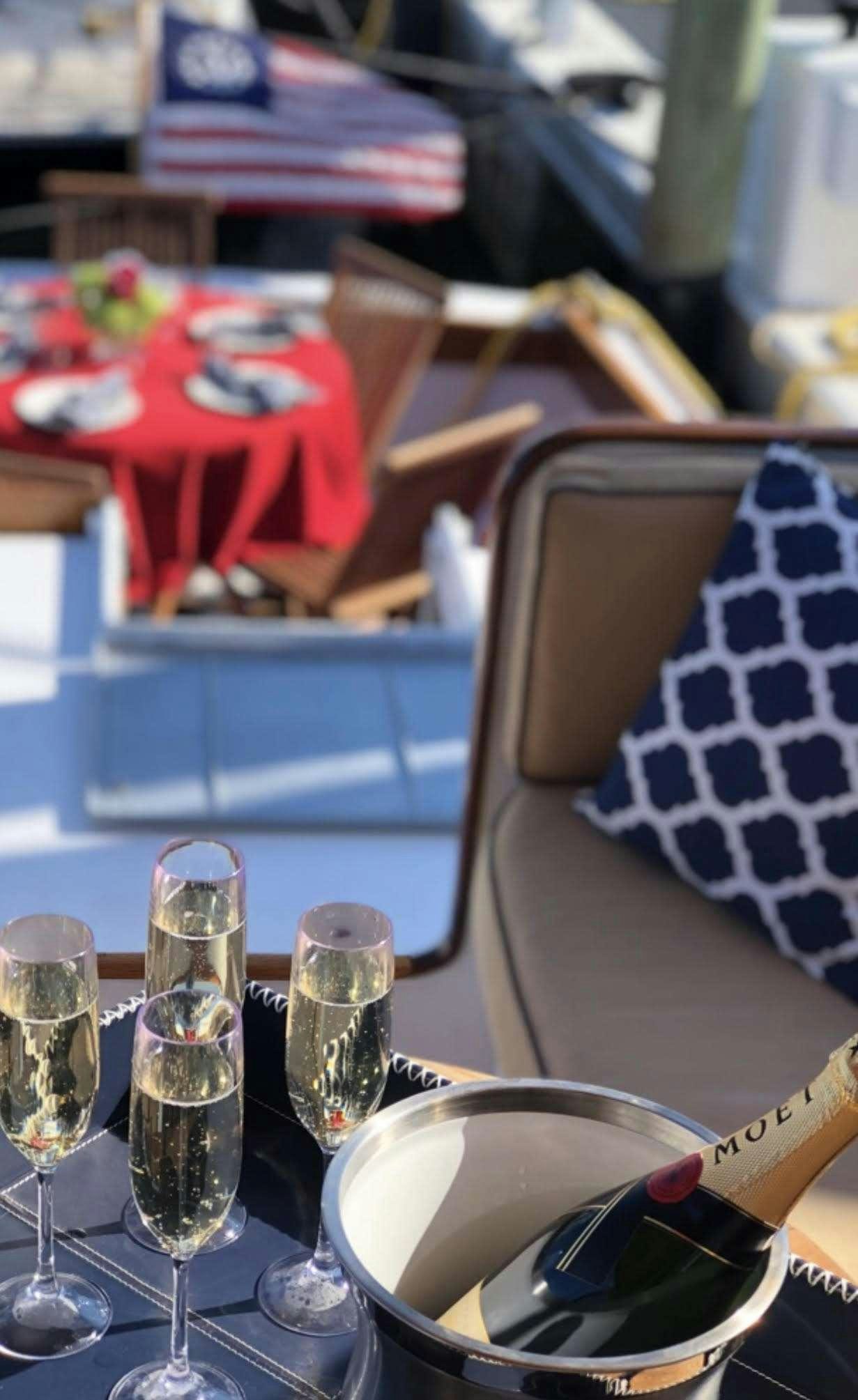a table with wine glasses and a book on it aboard KINGFISHER Yacht for Charter