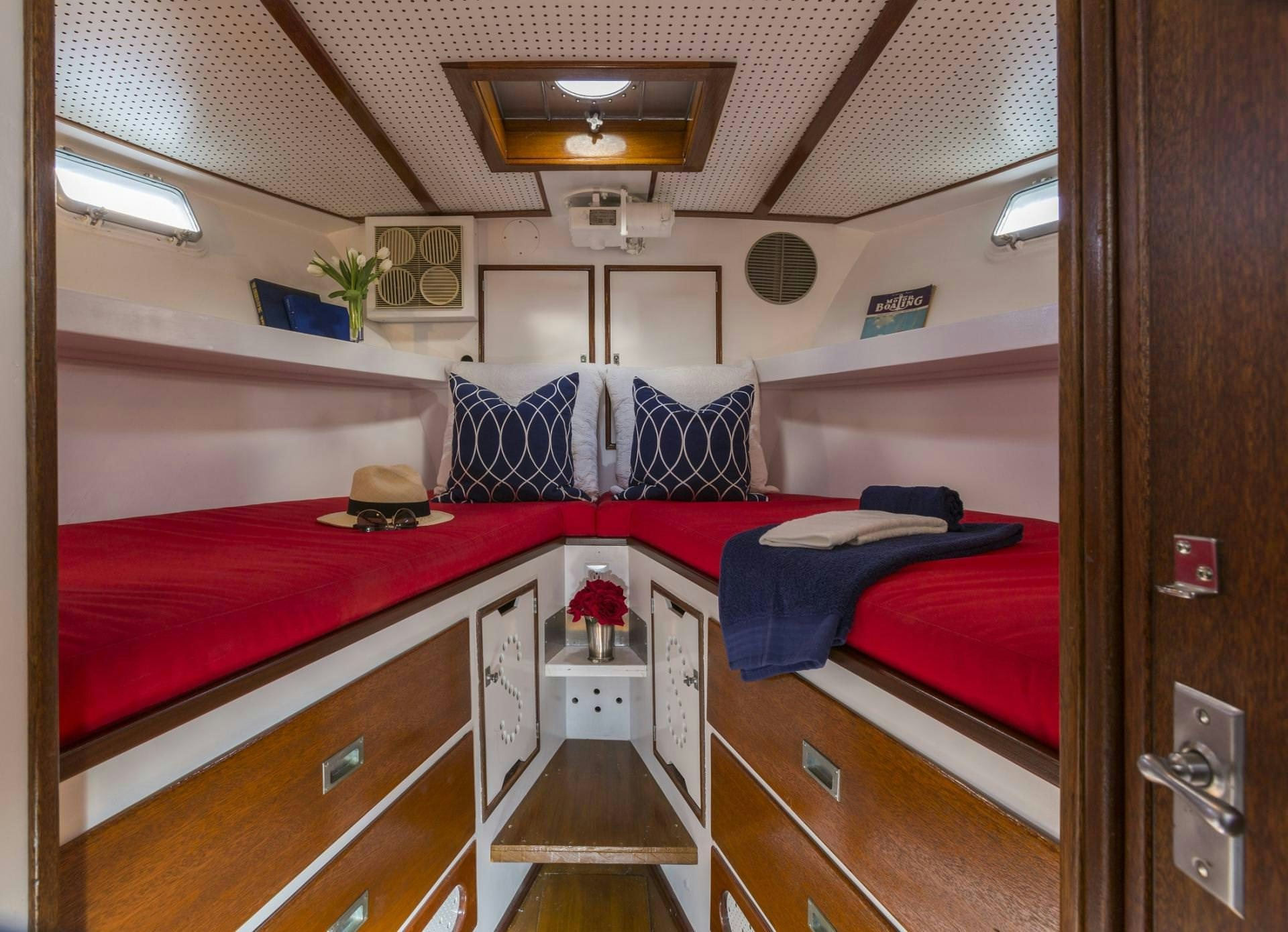a bedroom with a bed and a desk aboard KINGFISHER Yacht for Charter
