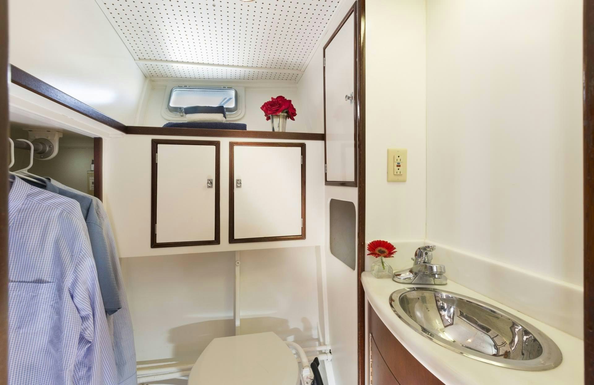 a bathroom with a sink and cabinets aboard KINGFISHER Yacht for Charter