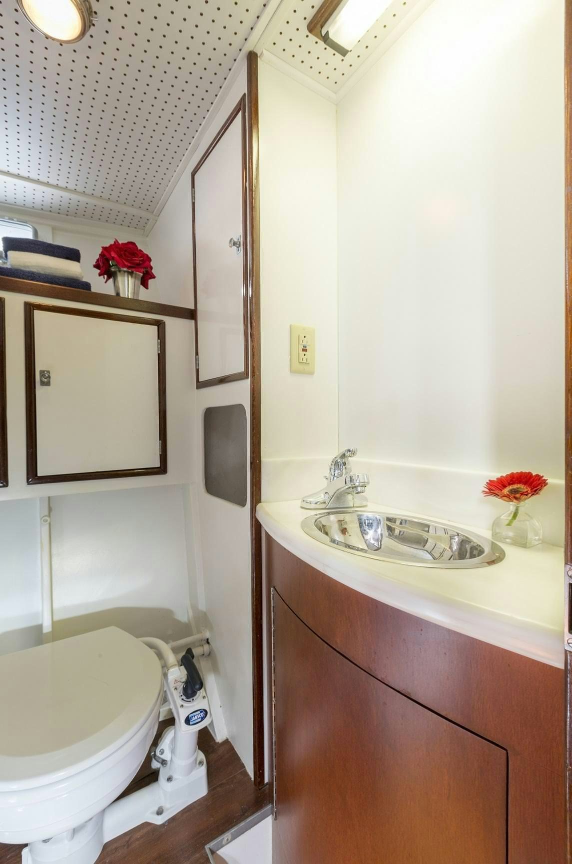 a bathroom with a sink and toilet aboard KINGFISHER Yacht for Charter