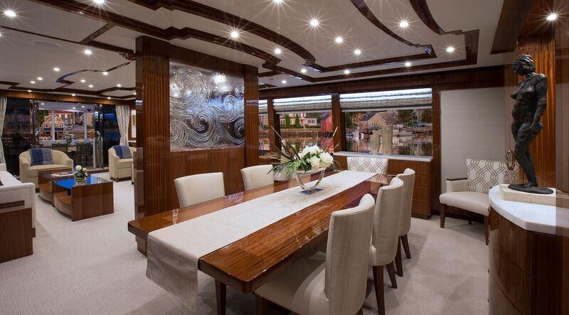 a room with a table chairs and a statue aboard RENAISSANCE Yacht for Charter