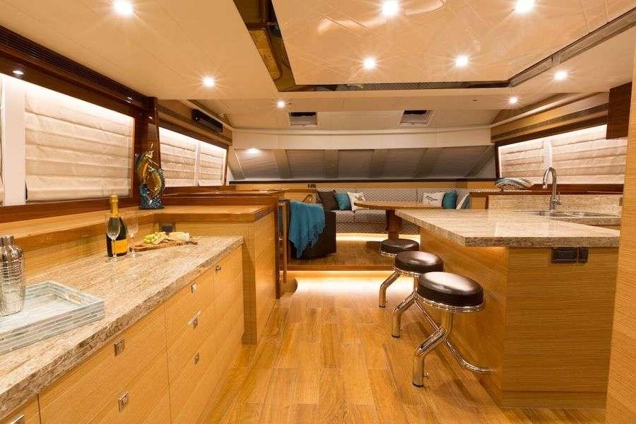 a kitchen with a bar stools and a bar stool aboard MYSTIC SOUL Yacht for Charter