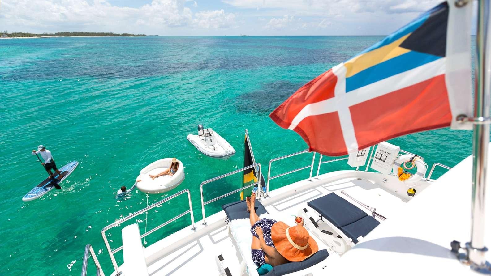 a boat with a flag on it aboard MYSTIC SOUL Yacht for Charter