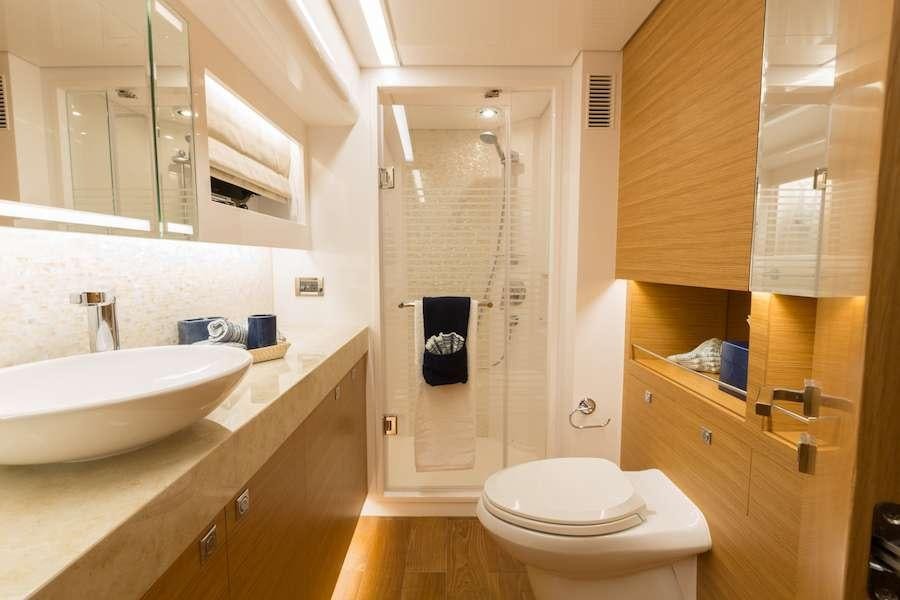 a bathroom with a sink toilet and shower aboard MYSTIC SOUL Yacht for Charter