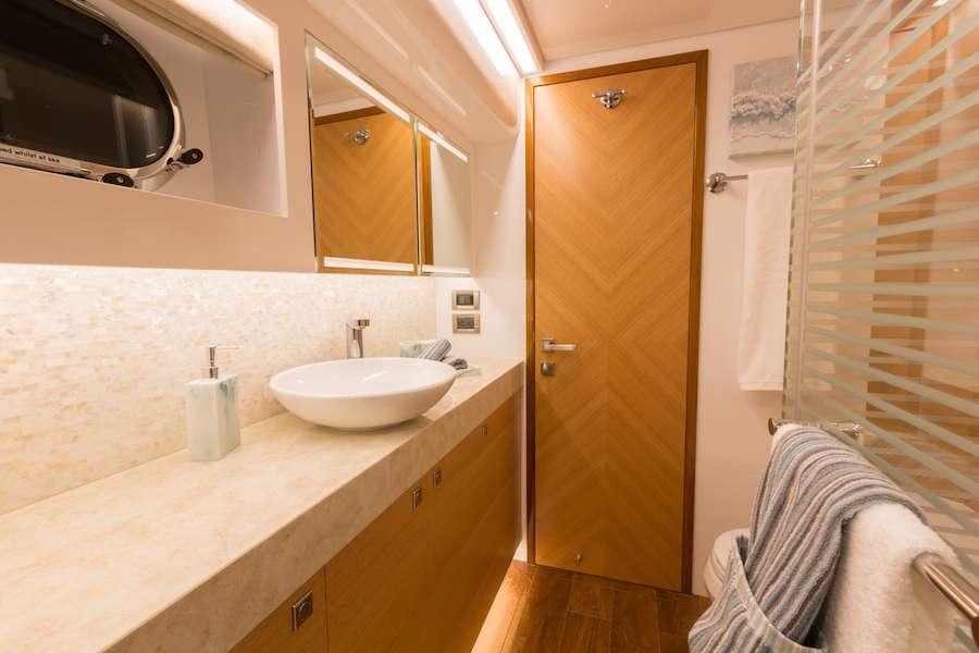 a bathroom with a sink and a microwave aboard MYSTIC SOUL Yacht for Charter
