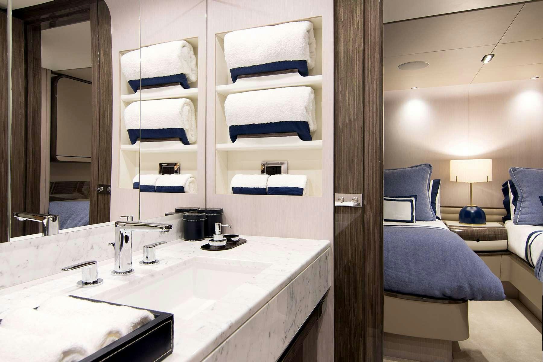 a bathroom with a sink and a bed aboard MEMORIES TOO Yacht for Charter