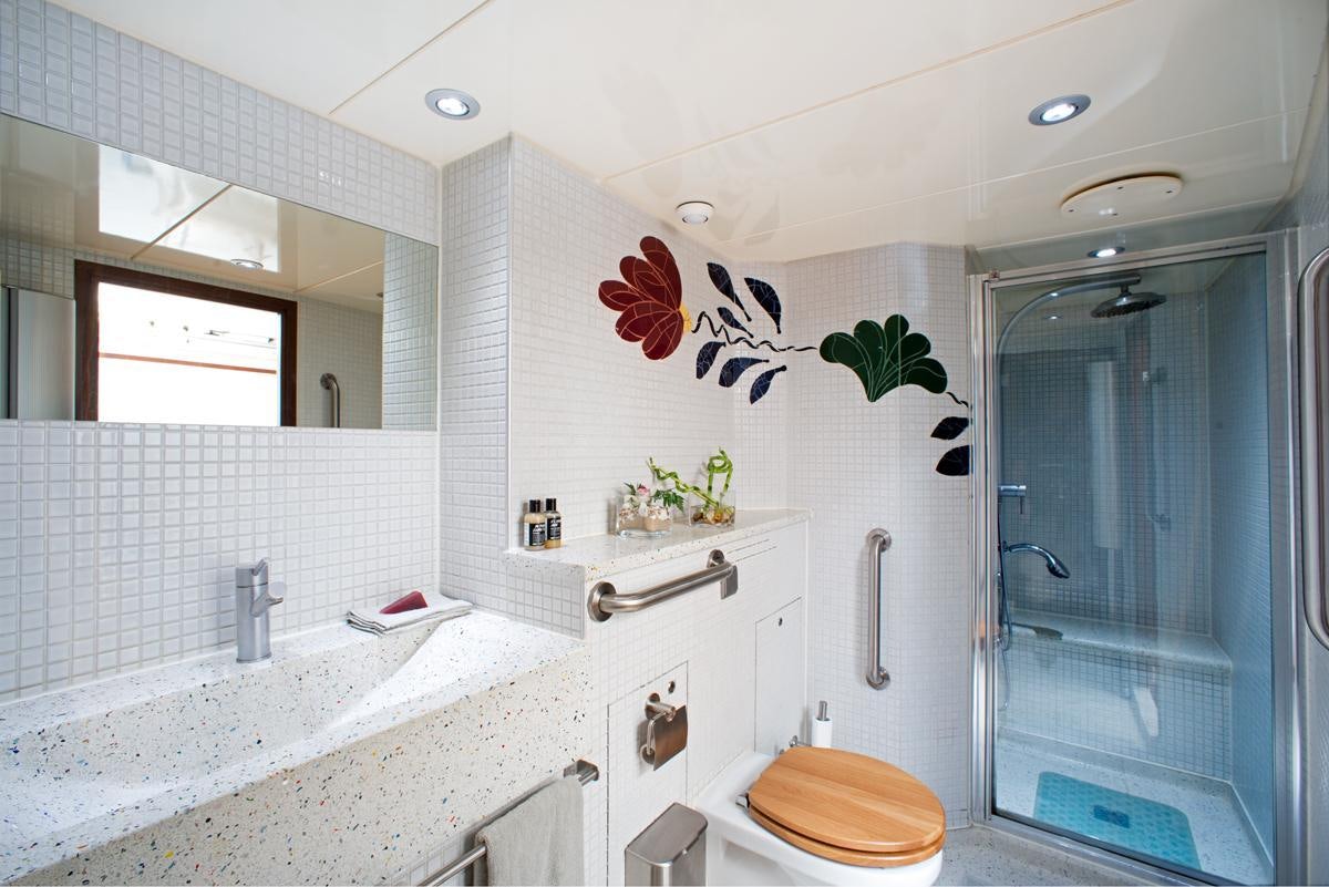 a bathroom with a shower and sink aboard DWINGER Yacht for Charter