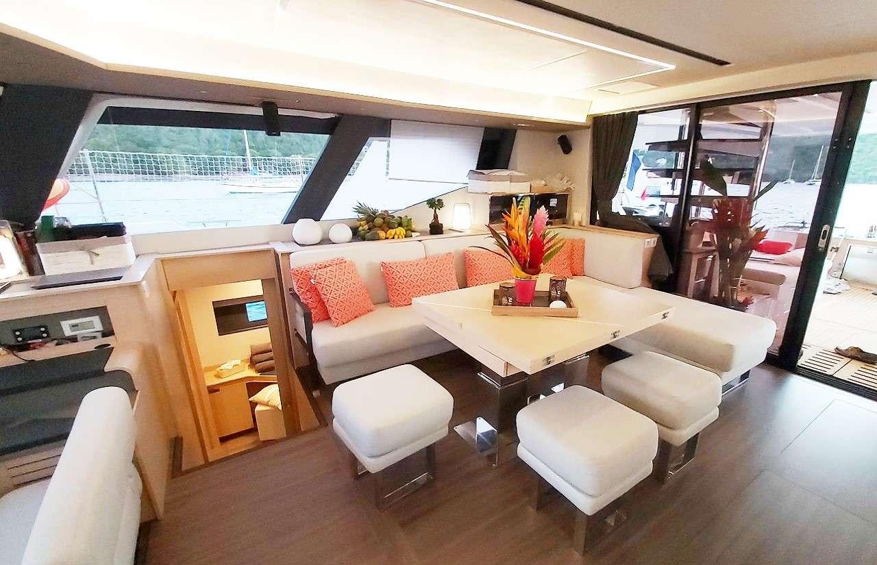 a living room with a couch and a table aboard BLACK CAT Yacht for Charter