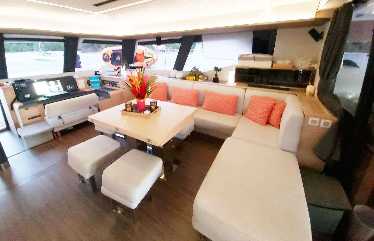 a living room with a couch and a table aboard BLACK CAT Yacht for Charter