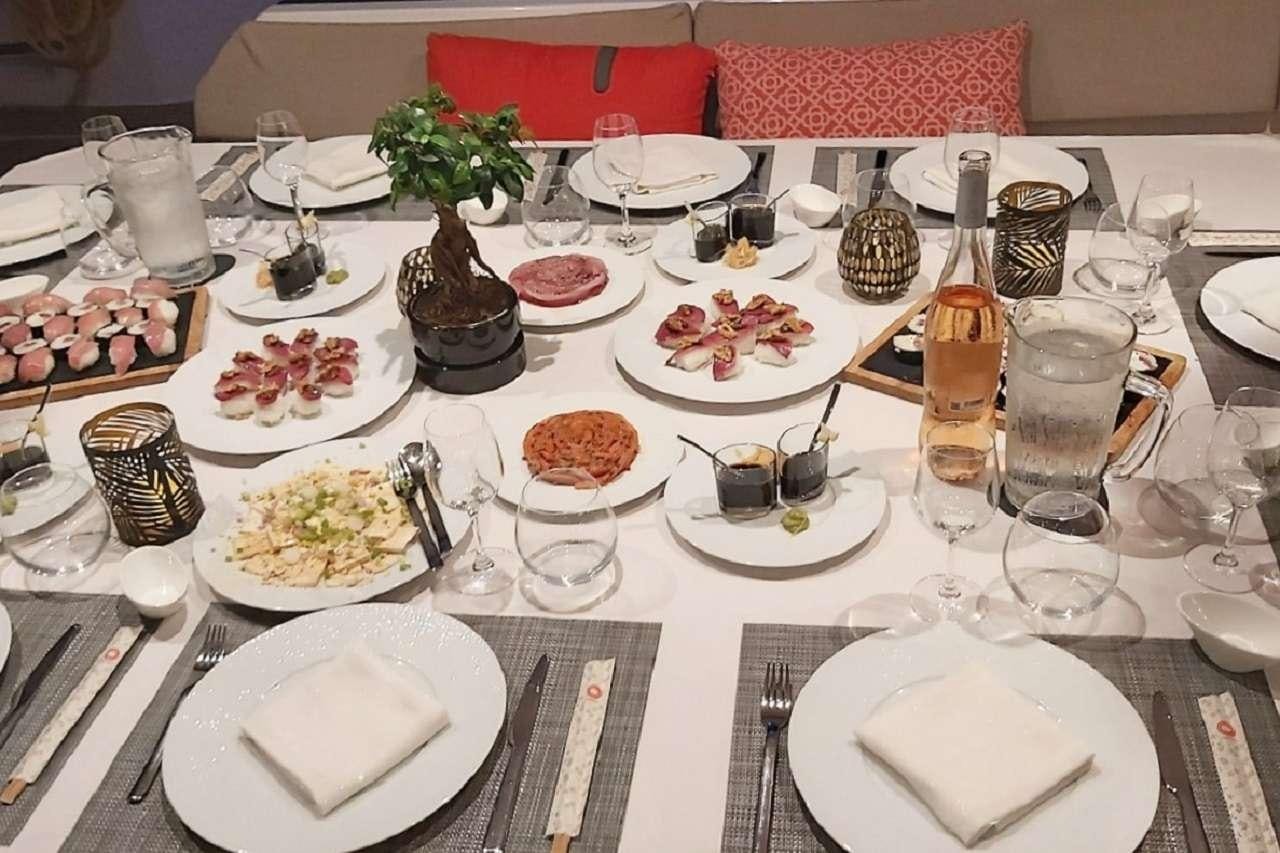 a table with plates and glasses aboard BLACK CAT Yacht for Charter