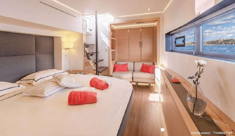 a room with a bed and a table aboard BLACK CAT Yacht for Charter