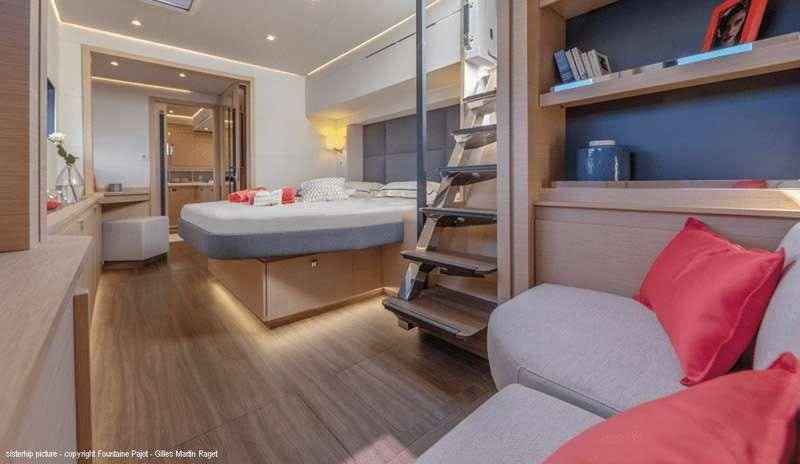 a bedroom with a bed and a ladder aboard BLACK CAT Yacht for Charter