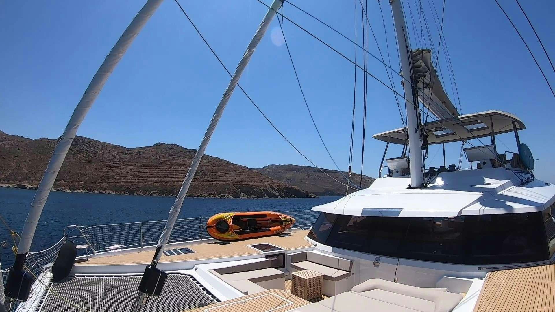 a boat and a kayak on a boat aboard BLACK CAT Yacht for Charter