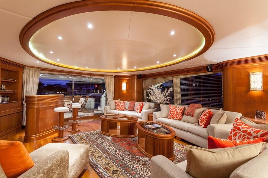 a large living room with a large chandelier aboard HAPPY HOUR Yacht for Charter