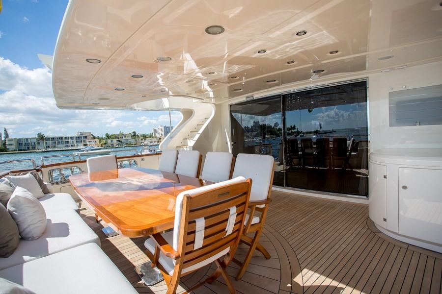 a room with a table chairs and a large window aboard HAPPY HOUR Yacht for Charter