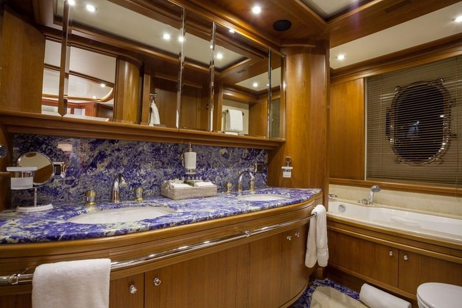 a bathroom with a large mirror aboard HAPPY HOUR Yacht for Charter