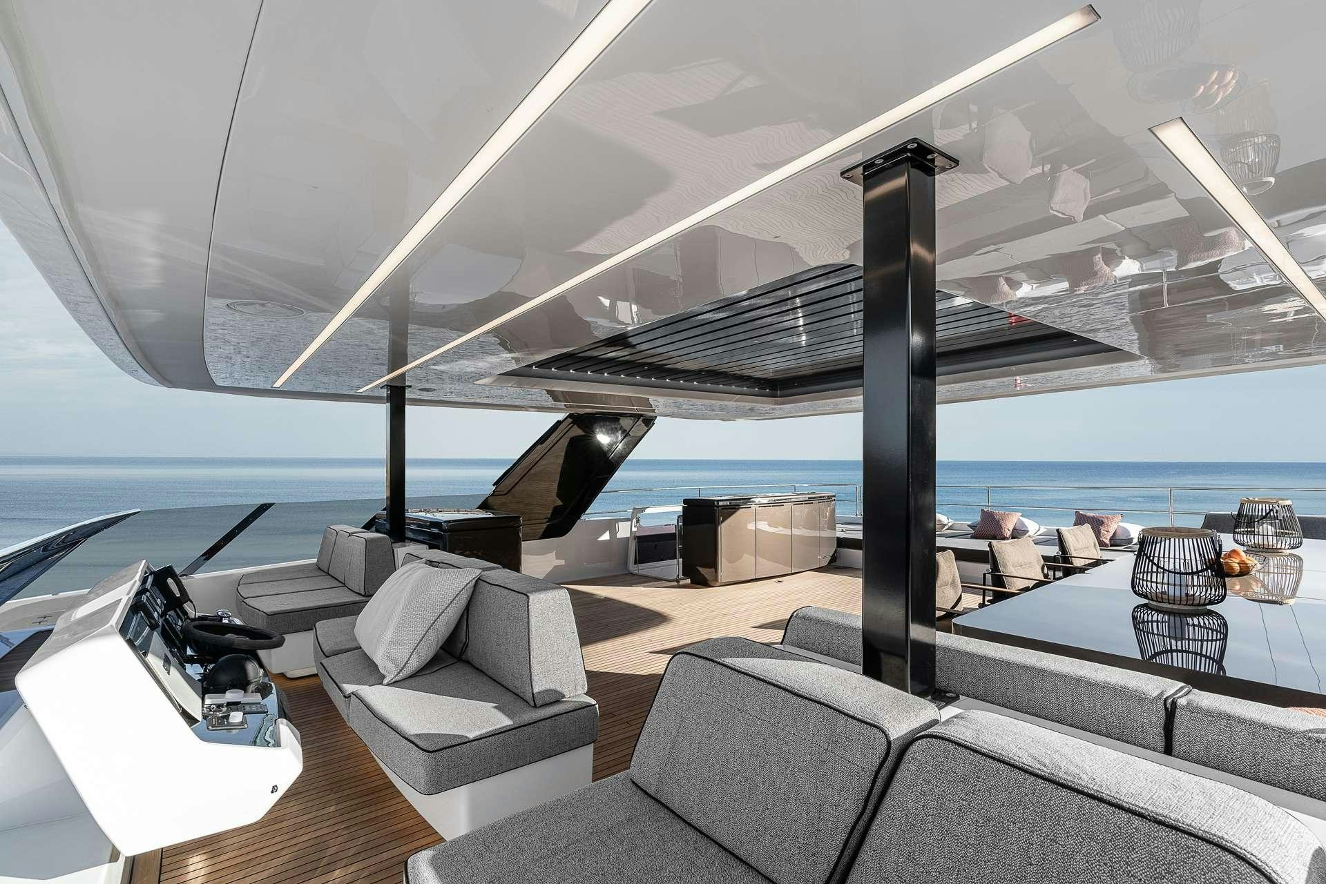 a room with a large white lounge chair and a large body of water aboard SEIYA Yacht for Charter