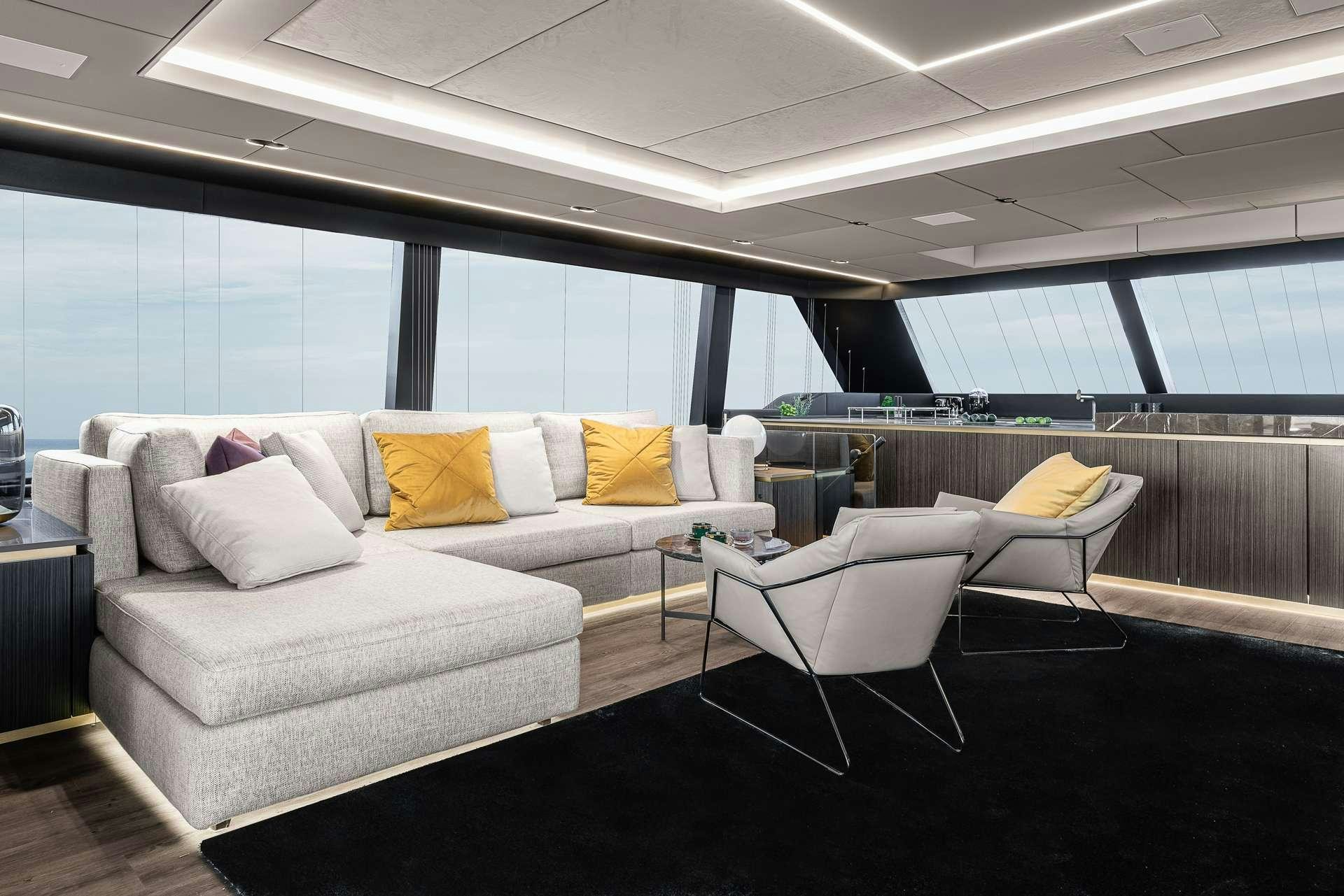 a living room with a couch and a large window aboard SEIYA Yacht for Charter