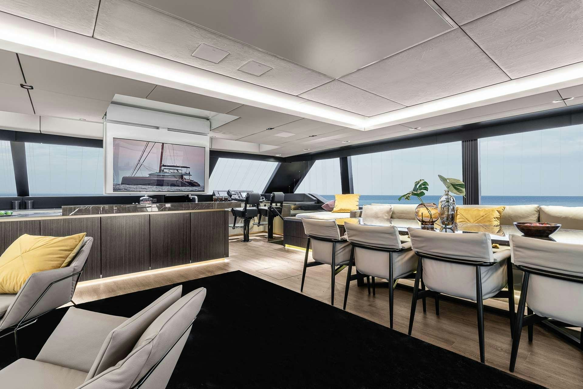 a room with a couch and a table and chairs aboard SEIYA Yacht for Charter