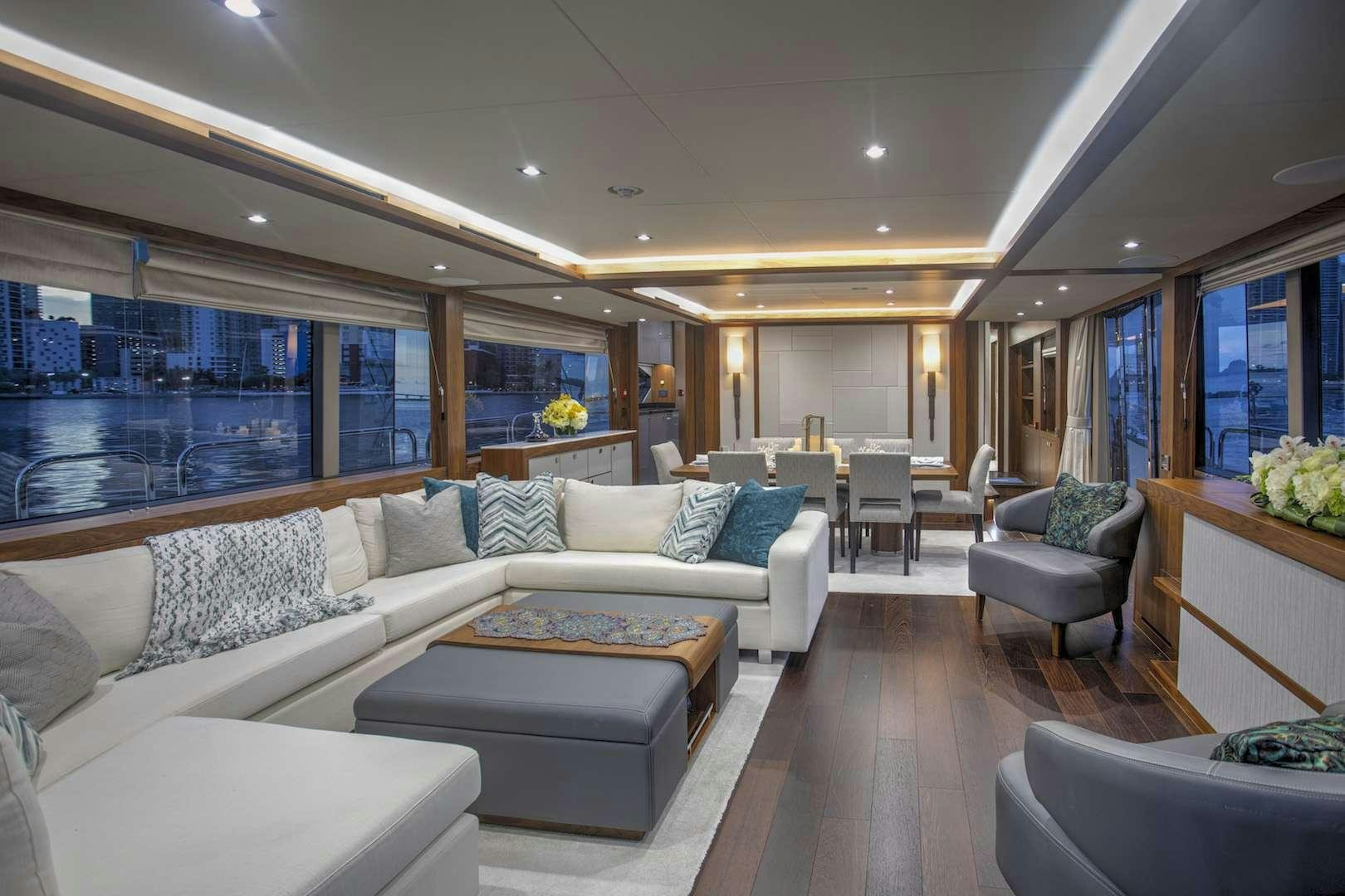 a living room with a large window aboard PERSEVERANCE 3 Yacht for Charter