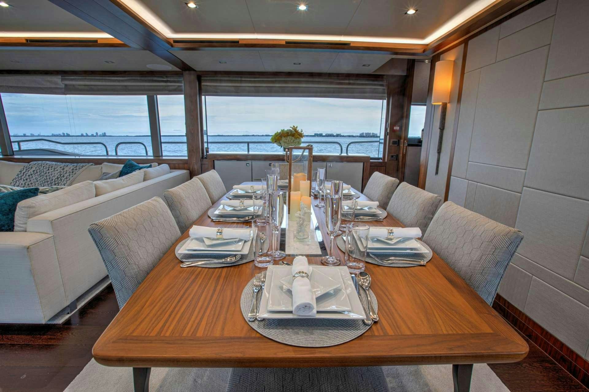 a table with plates and glasses on it aboard PERSEVERANCE 3 Yacht for Charter