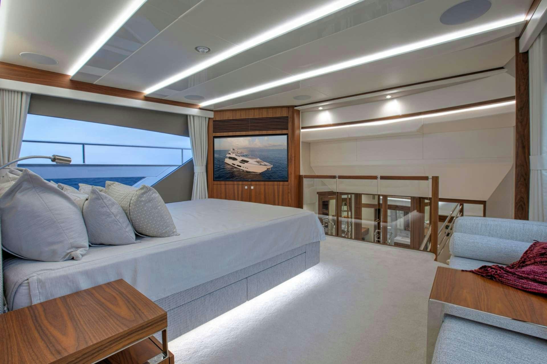 a room with a bed and a couch aboard PERSEVERANCE 3 Yacht for Charter