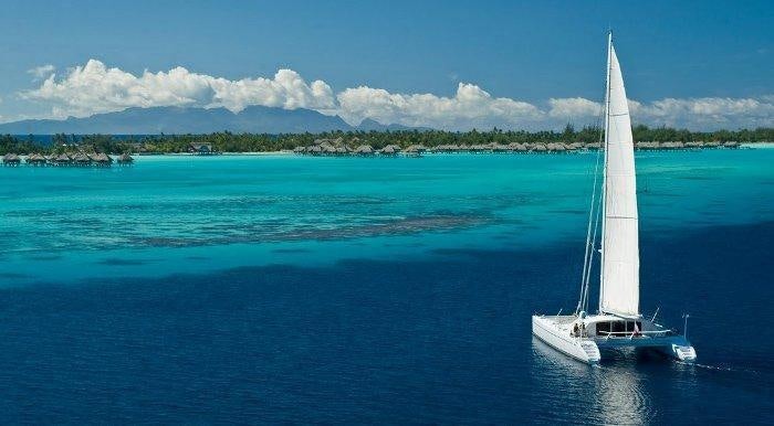 a boat sailing in the sea aboard MAGIC CAT Yacht for Charter