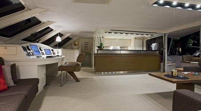 a room with a desk and a couch and a laptop aboard MAGIC CAT Yacht for Charter