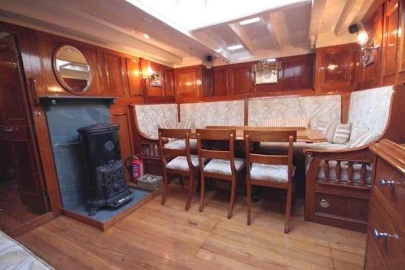 a kitchen with a bar and chairs aboard Halcyon Yacht for Charter