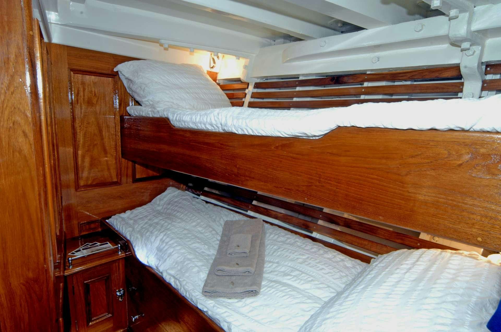 a bed with a book on it aboard Halcyon Yacht for Charter