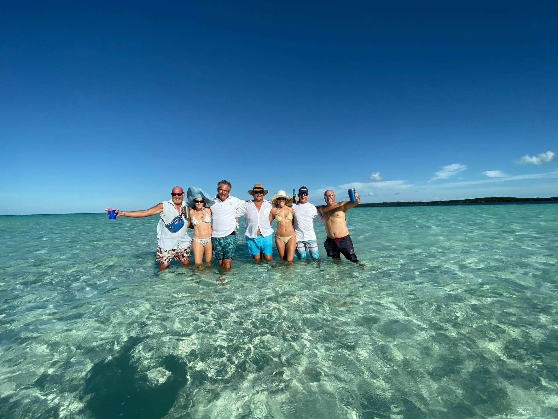 a group of people standing in water aboard Samoru ll Yacht for Charter