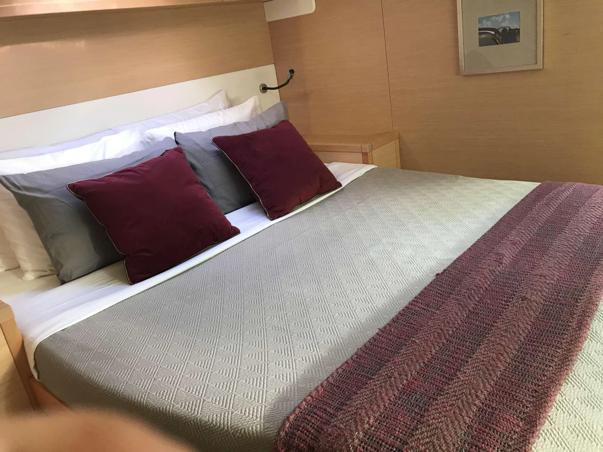 a bed with pillows aboard Samoru ll Yacht for Charter