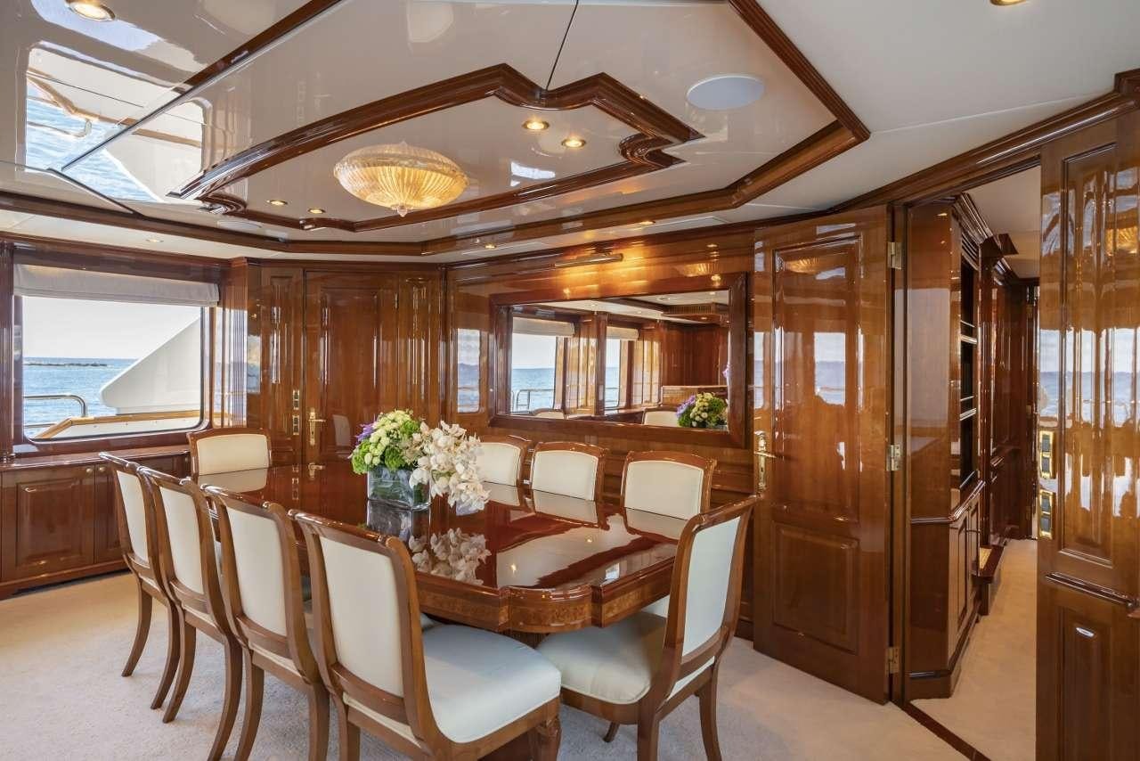 a dining room with a wood paneled ceiling aboard AURA Yacht for Charter