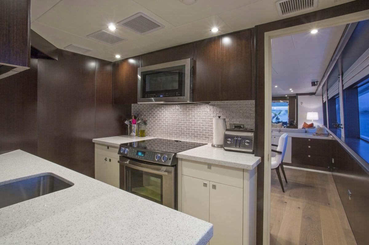 a kitchen with a countertop sink and a microwave aboard LADY CARMEN Yacht for Charter