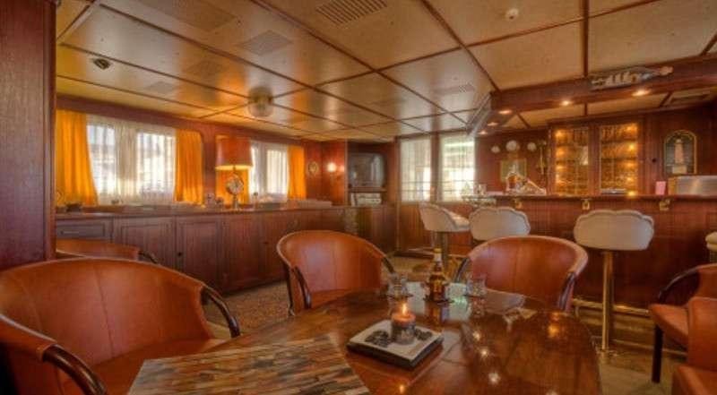 a room with a table chairs and a window aboard SANSSOUCI STAR Yacht for Charter