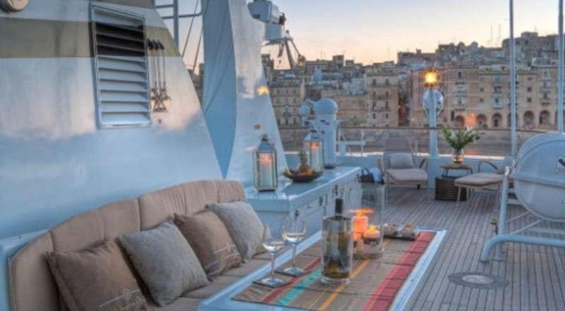 a balcony with a view of a city aboard SANSSOUCI STAR Yacht for Charter