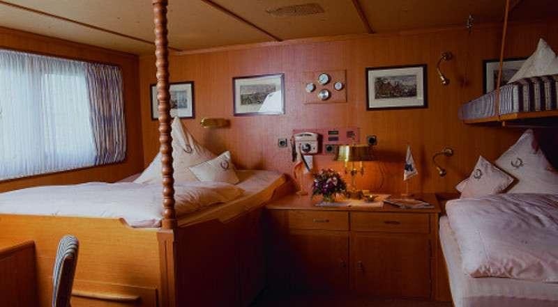 a bedroom with a bed and a lamp aboard SANSSOUCI STAR Yacht for Charter