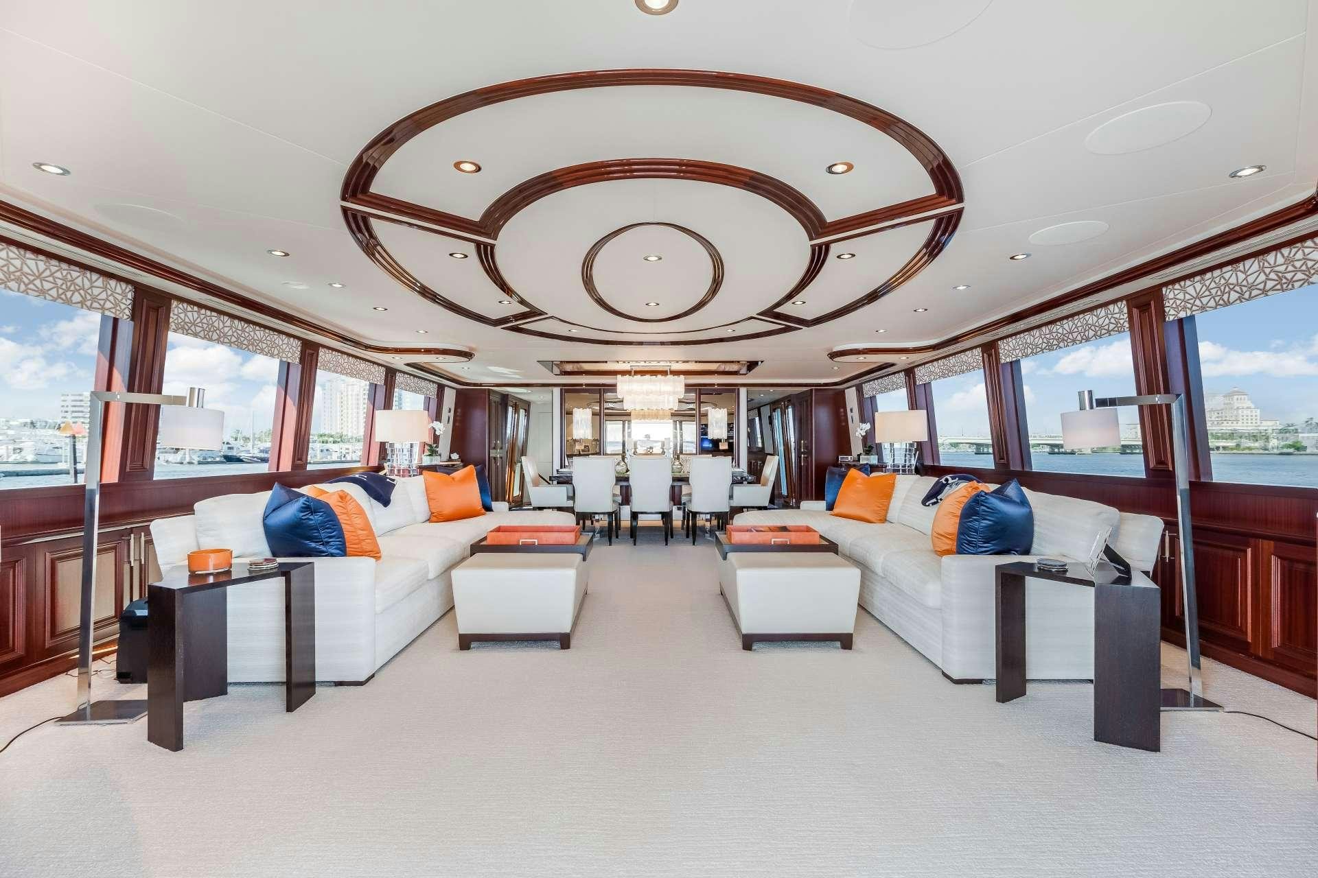a large room with a couch and a large chandelier aboard OUR HERITAGE Yacht for Charter