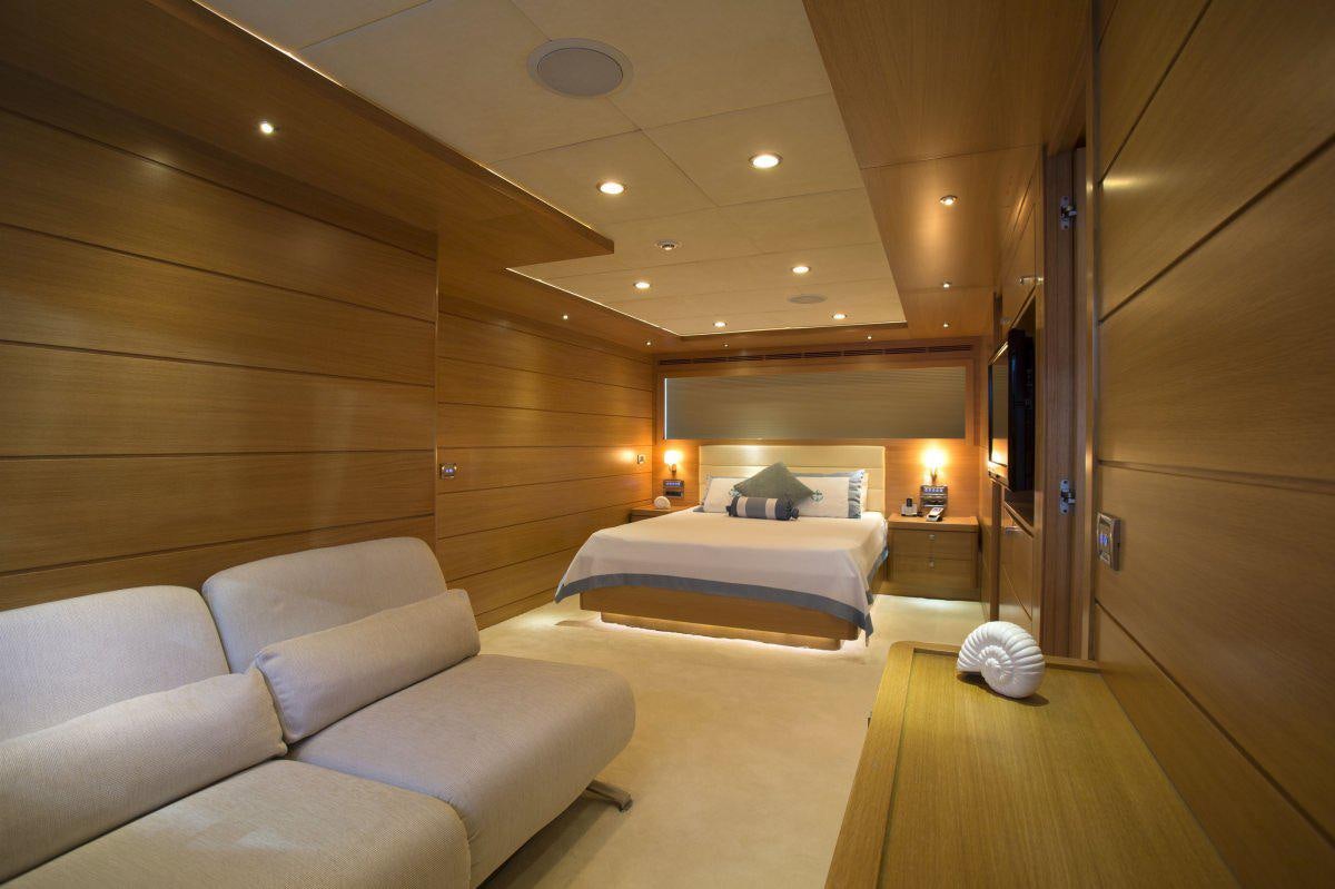 a room with a bed and a couch aboard PANFELISS Yacht for Charter